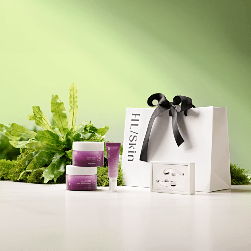 HL Skin Spring Bundle - Reset skincare trio with gift bag and greenery backdrop for hydration and regeneration.